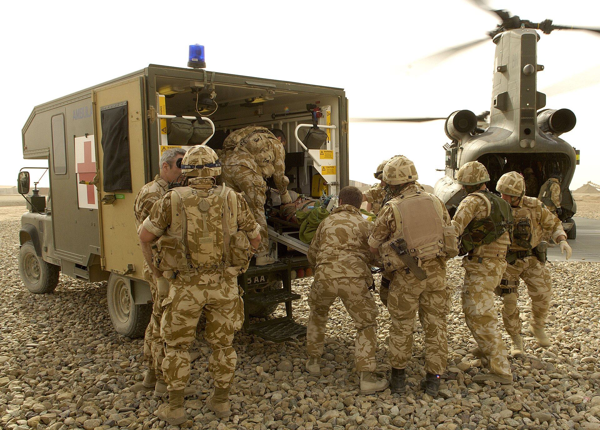 A Medical Emergency Response Team carries a casualty from an RAF Chinook to a waiting ambulance in Helmand, Afghanistan