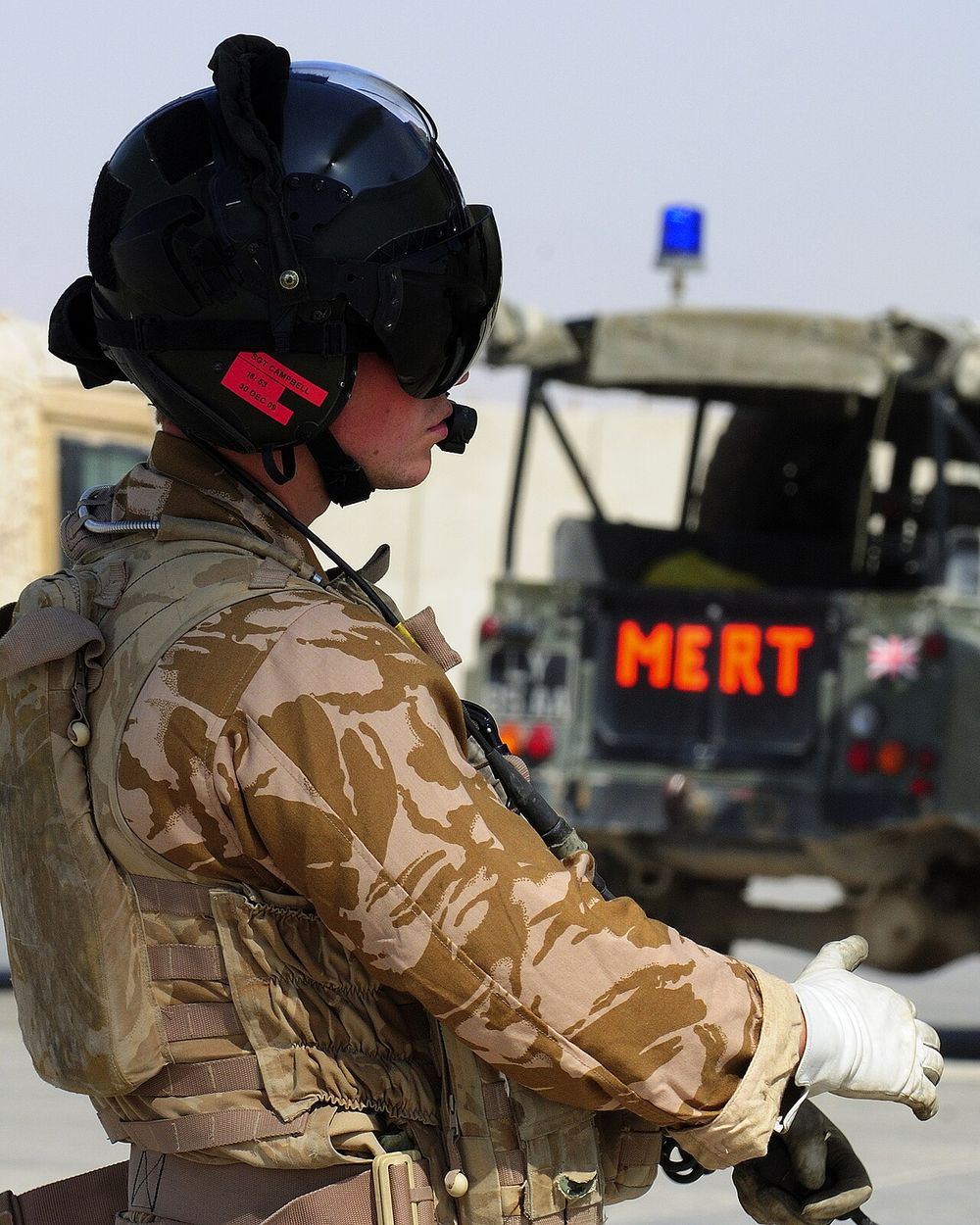 An RAF Chinook loadmaster watches the Medical Emergency Response Team embark at Camp Bastion